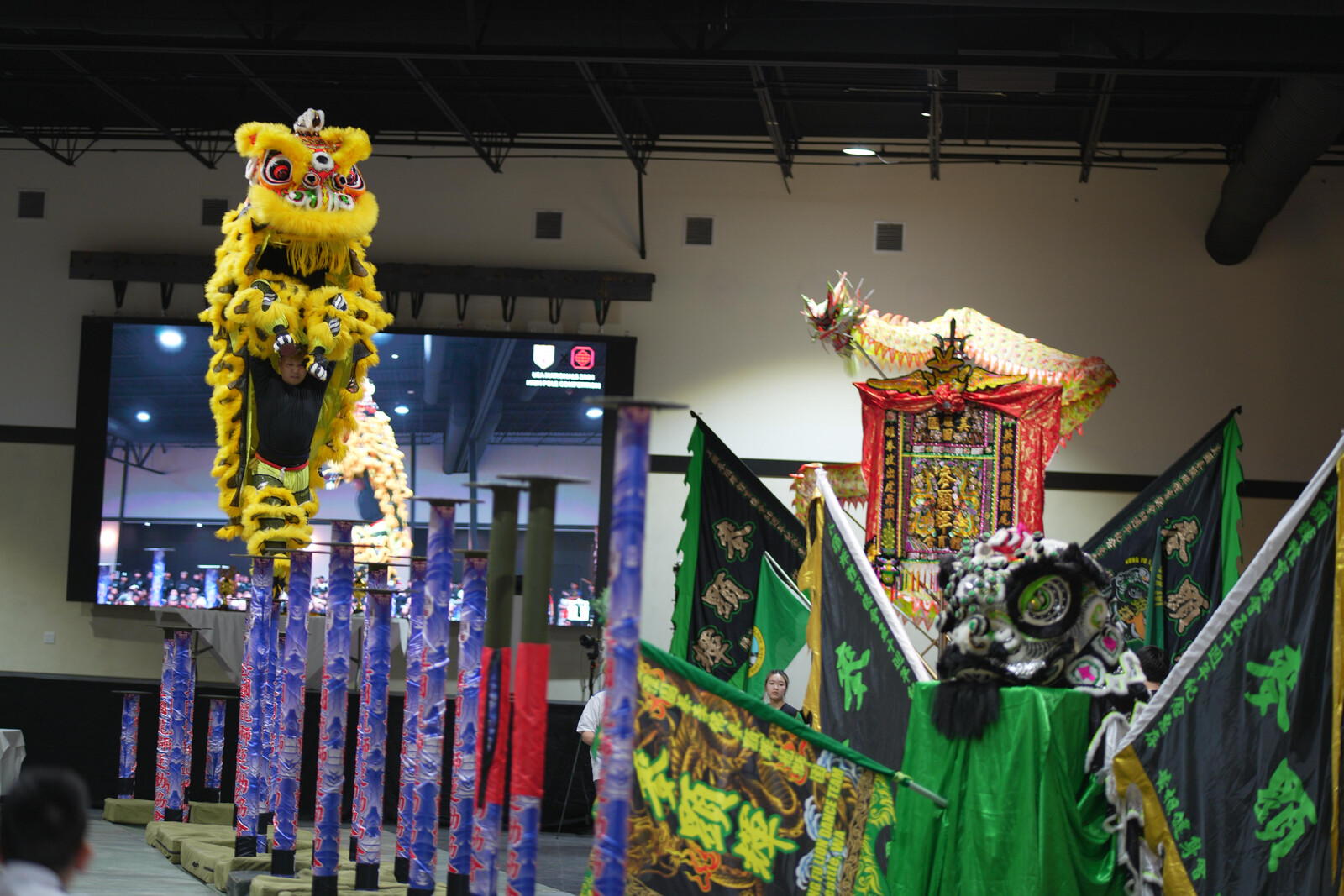 Mak Fai lion dancers performing with yellow lions under red lanterns